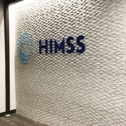 Custom acrylic lobby reception sign for HIMSS in Lowry, Denver, designed by Banner Signs Denver to create a polished and professional business environment.