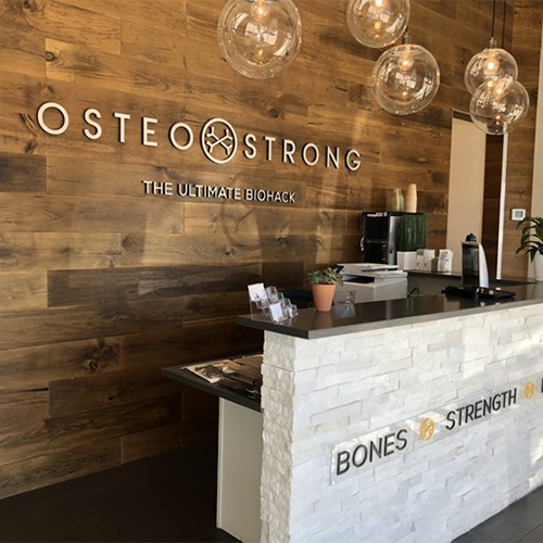 Custom aluminum interior lobby sign for Osteo Strong in Centennial, designed and installed by Banner Signs Denver to enhance branding and create a professional space.