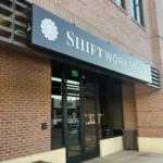 Push-through acrylic cabinet business sign for SHIFT Workspaces in Downtown Littleton, designed and installed by Banner Signs Denver to elevate brand visibility and modern appeal.